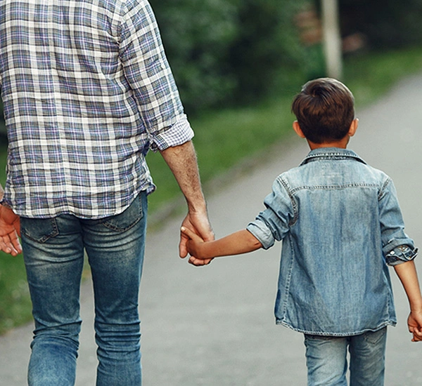 Man holding hand of his son